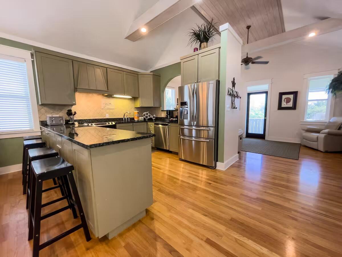 Image 3: Kitchen with sage cabinets