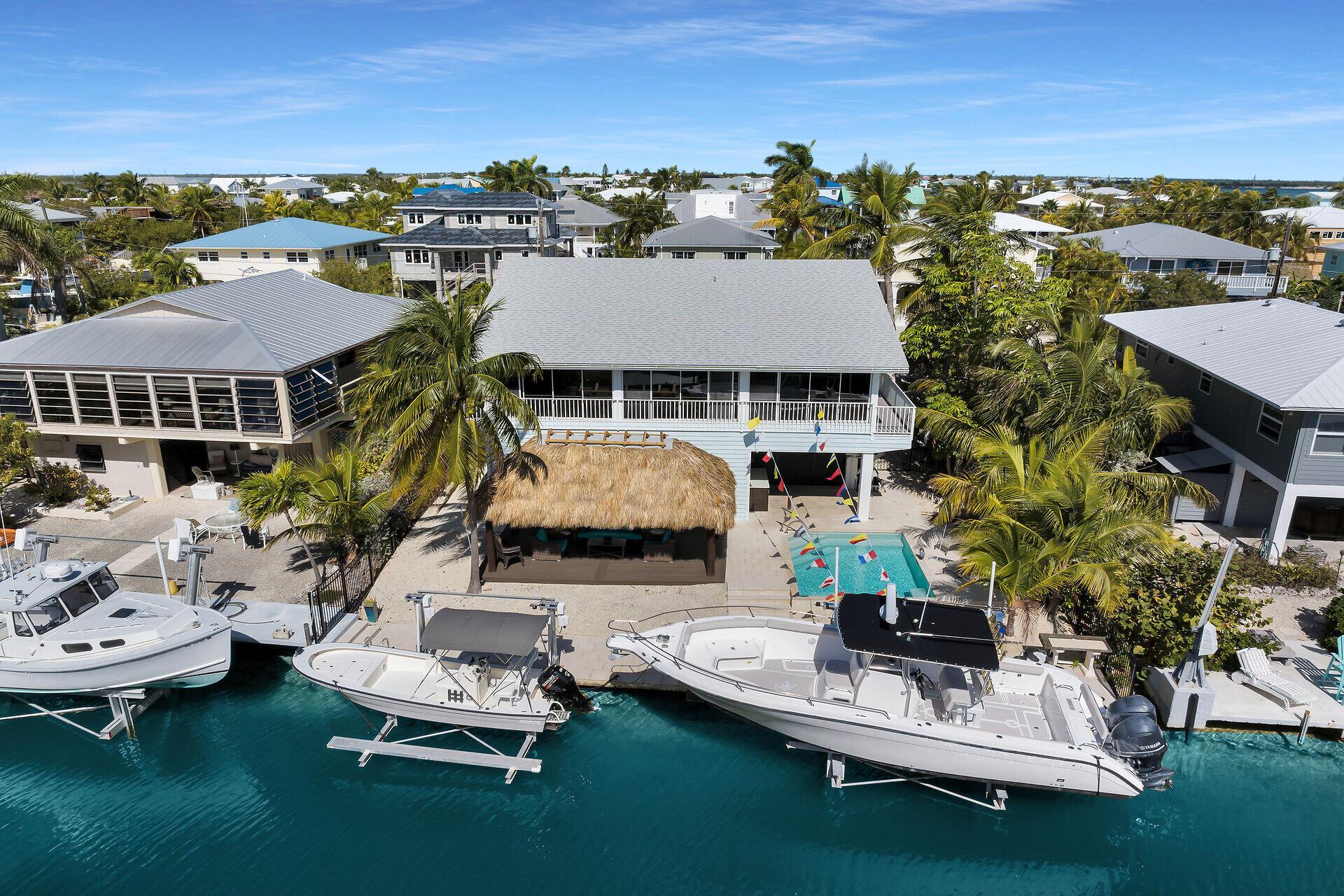 Image 2: Backyard with pool, tiki and 60 ft. dock
