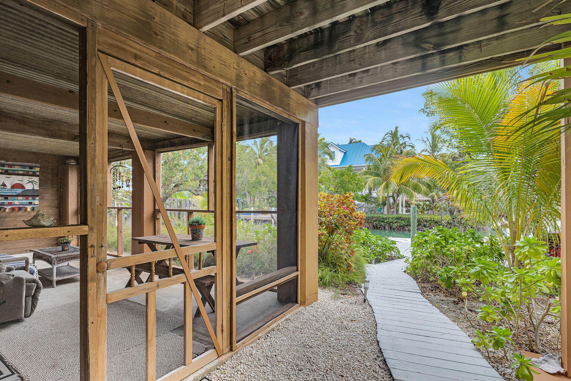 Image 3: Screened sitting area & walkway to dock