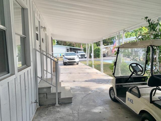 Image 3: CARPORT AND ENTRANCE TO HOME