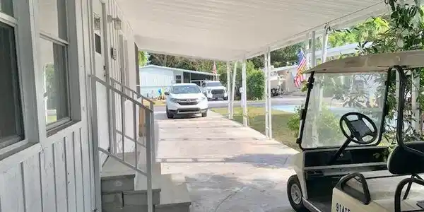 Image 3: CARPORT AND ENTRANCE TO HOME