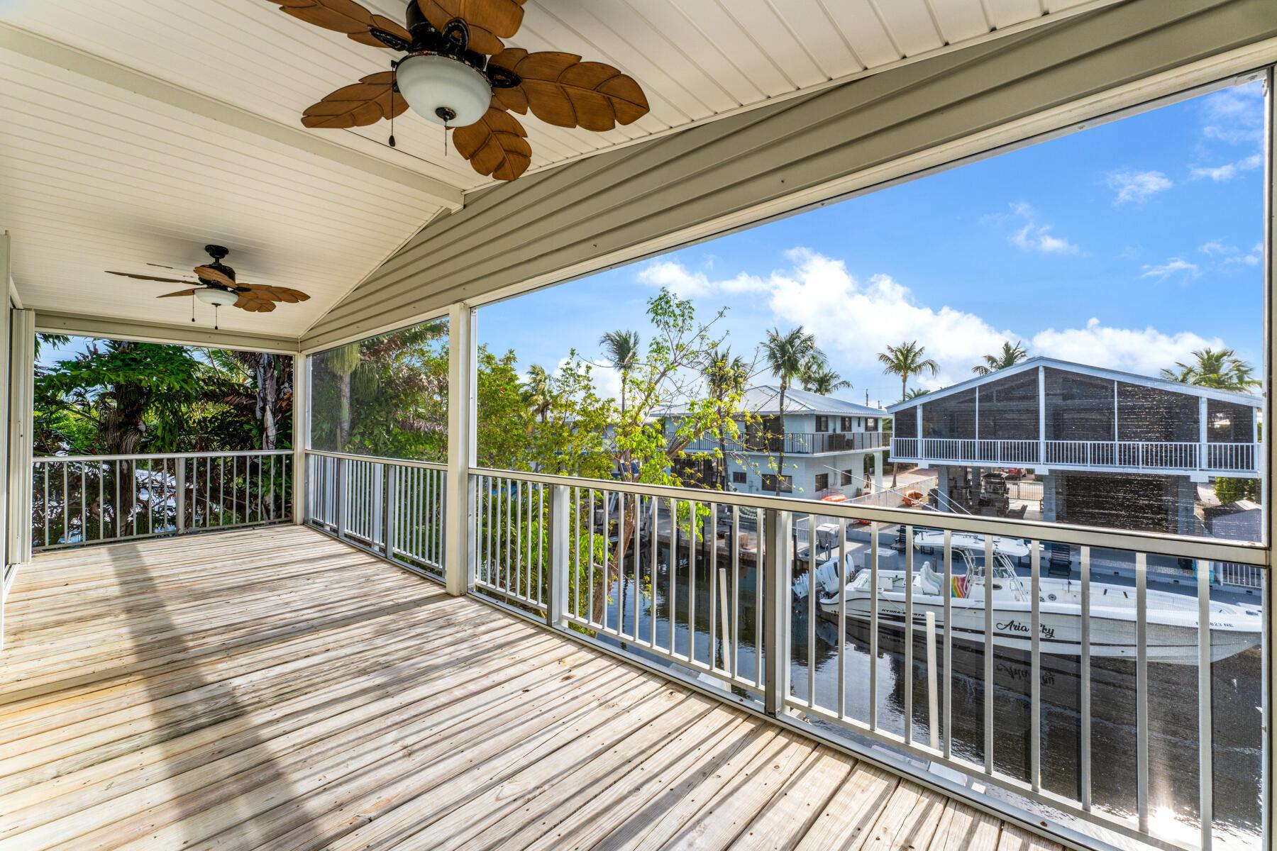 Image 2: Screened porch overlooking quiet canal