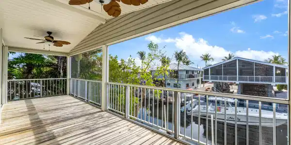 Image 2: Screened porch overlooking quiet canal