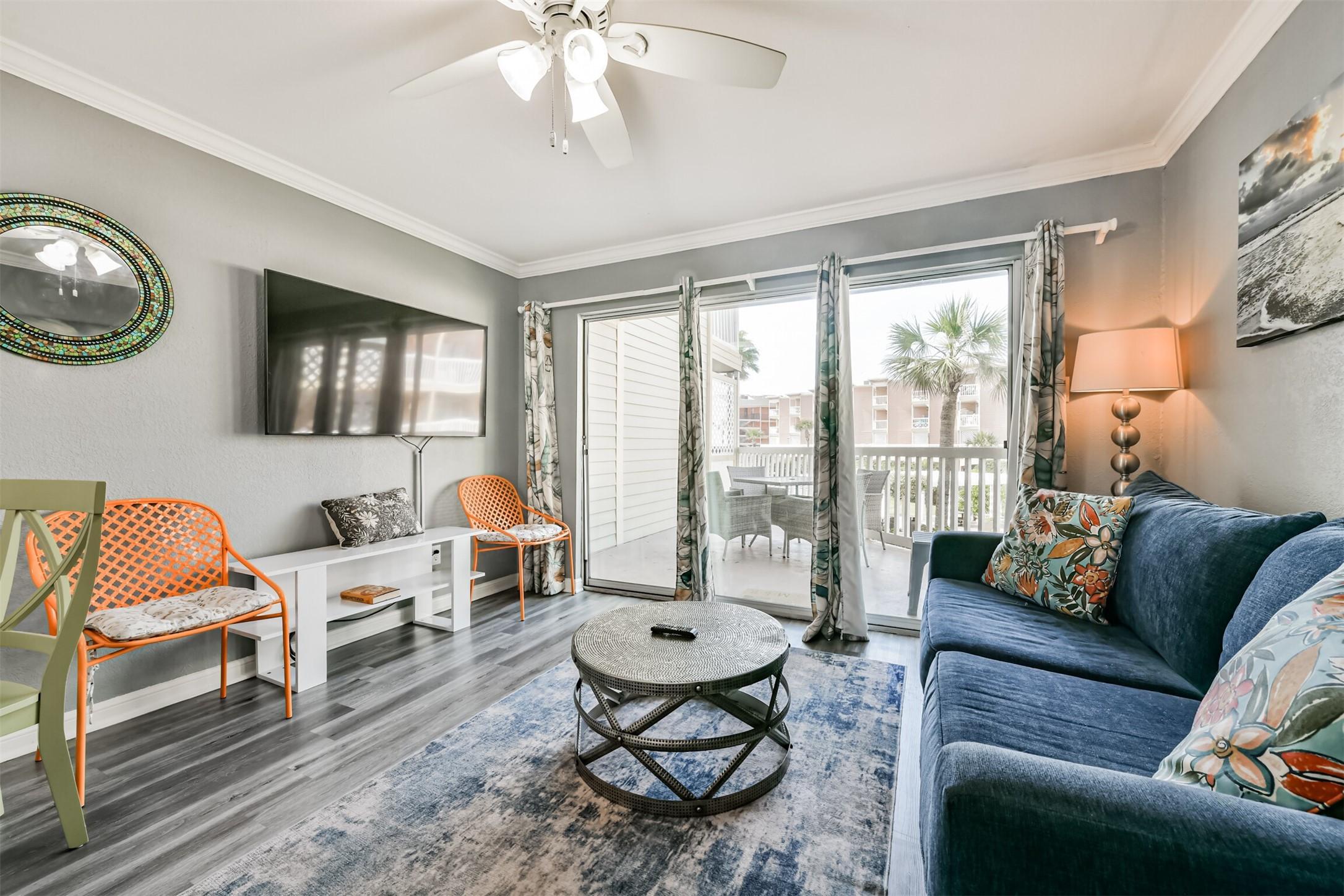 Image 2: This inviting living room boasts serene views of t