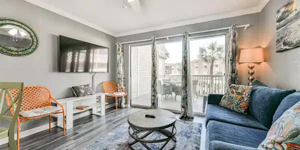 Image 2: This inviting living room boasts serene views of t