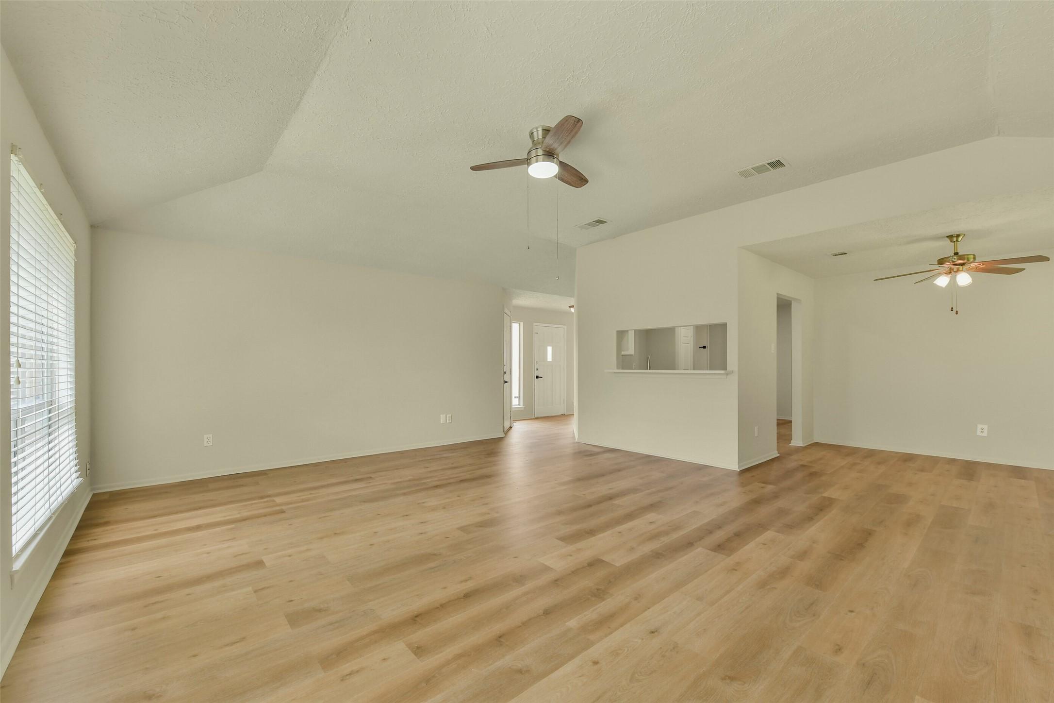 Image 3: This view shows the living room open to the dining