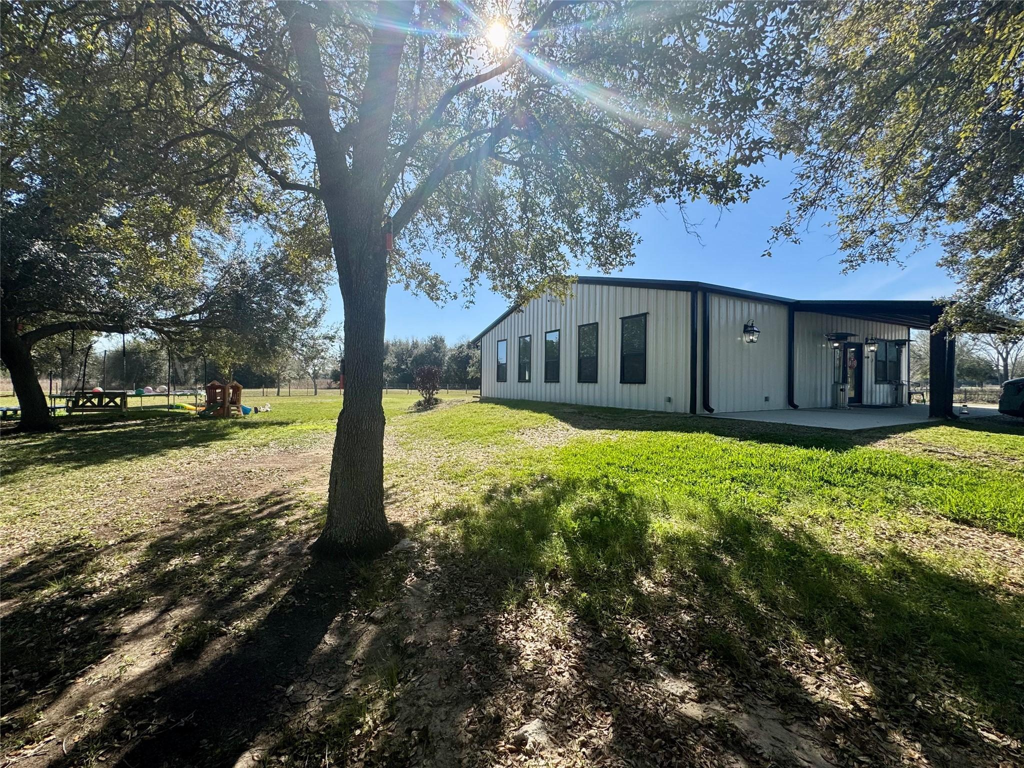 Image 3: Side view with mature trees that gives plenty of s