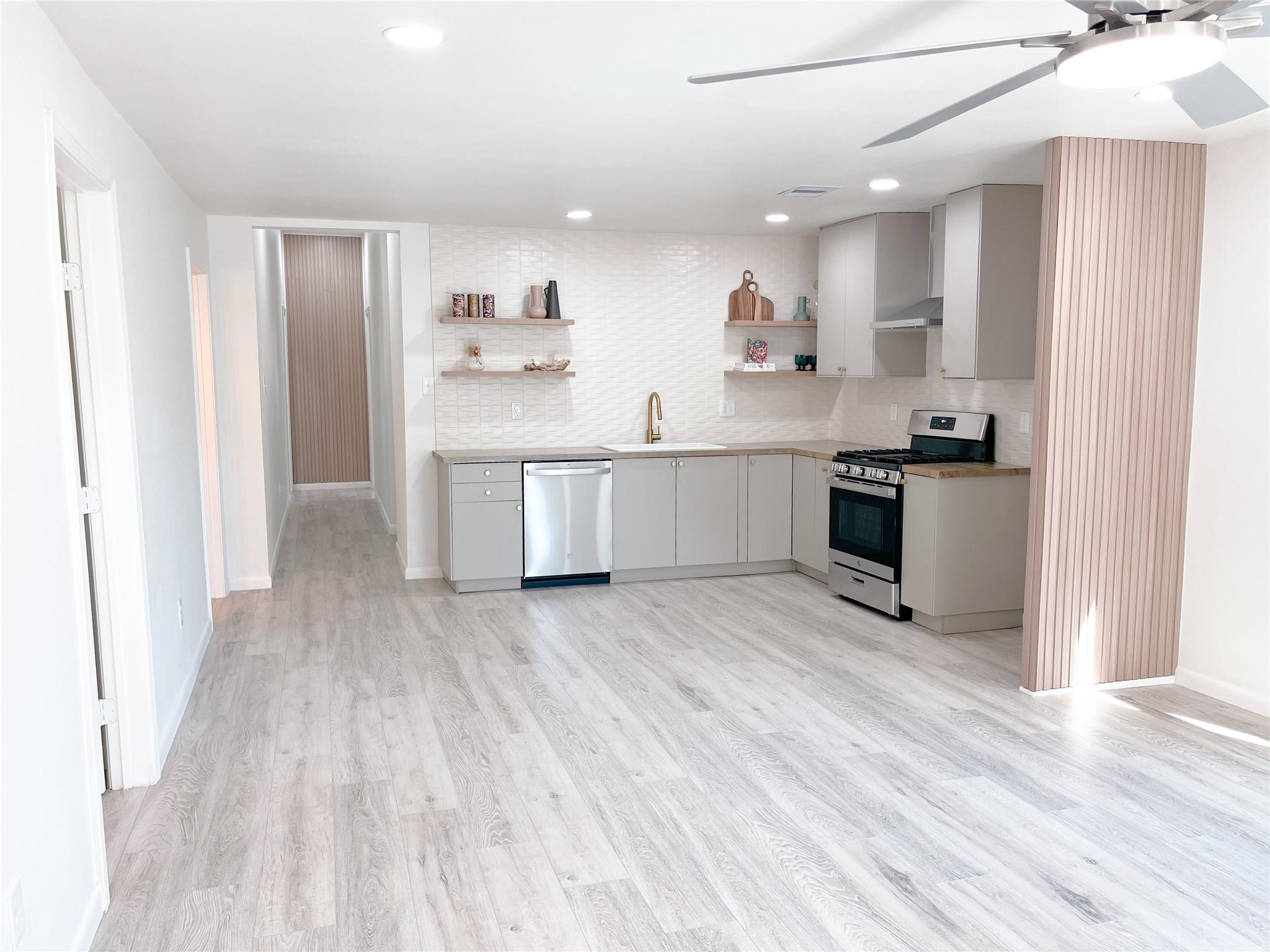 Image 4: warm earth-tone colors and tiled backsplash adds a
