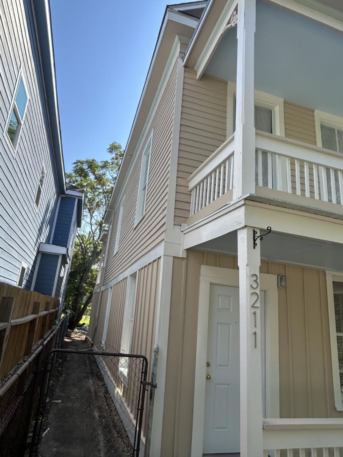 Image 3: East side of the house. Backyard is fenced.