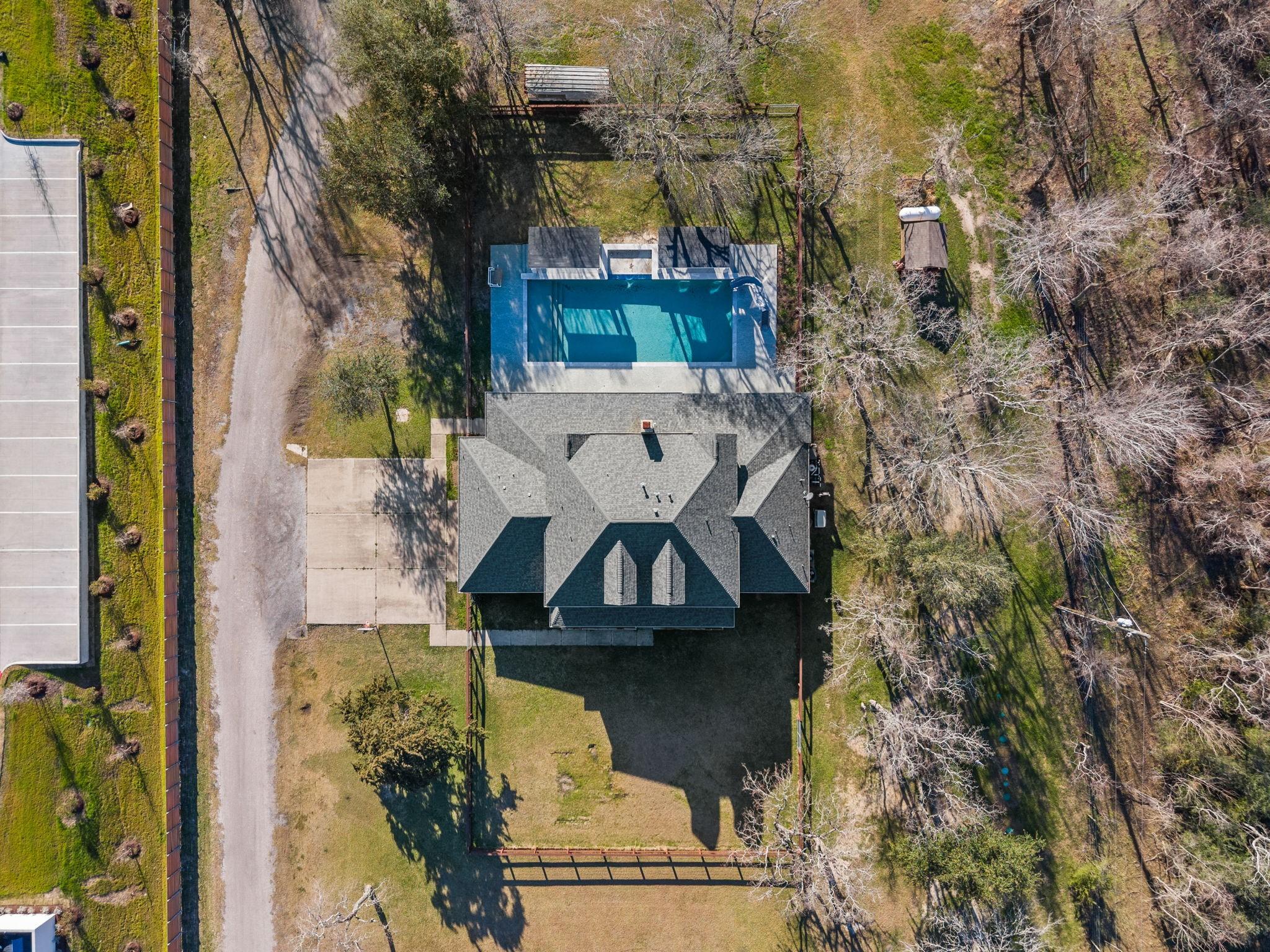 Image 4: This aerial photo shows a spacious house with a la