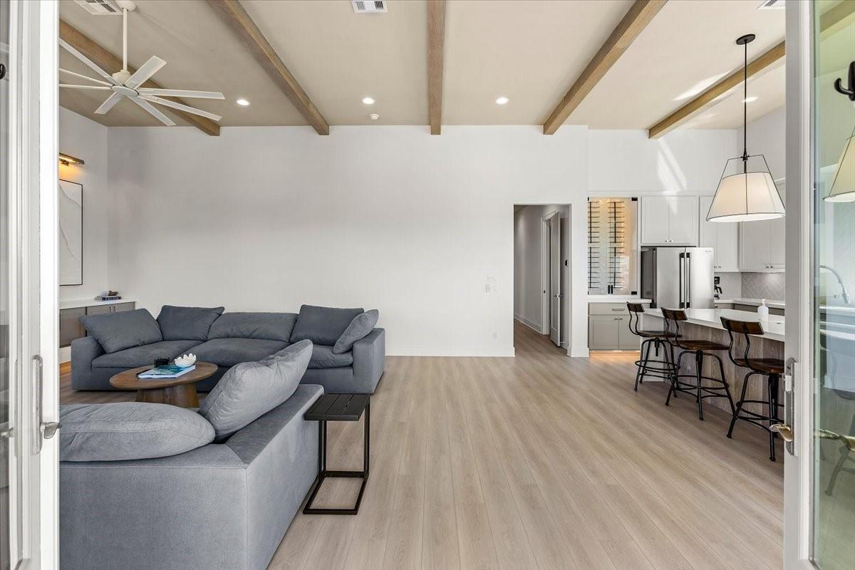 Image 4: Spacious open-concept living area featuring a mode
