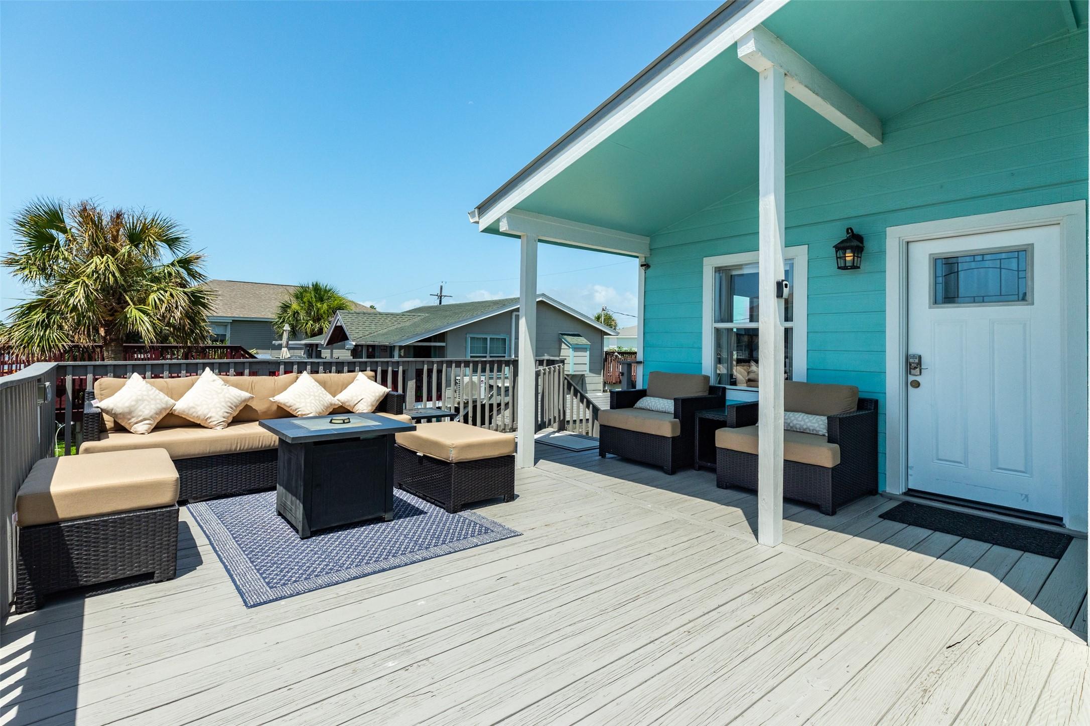 Image 3: Large deck space with plenty of seating and a fire