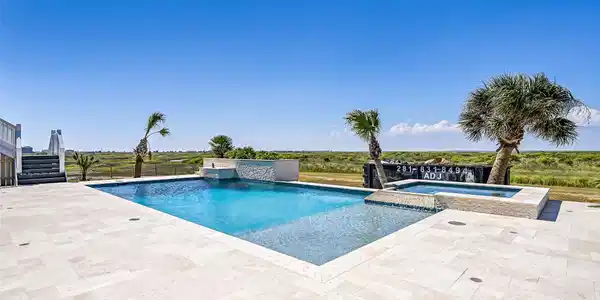 Image 4: A 32,000-gallon saltwater pool and spa bring resor