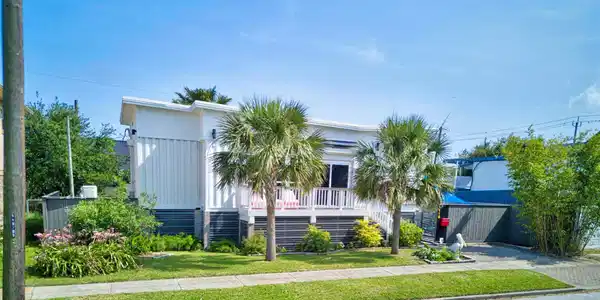 Image 2: Front Elevation With Manicured Landscaping