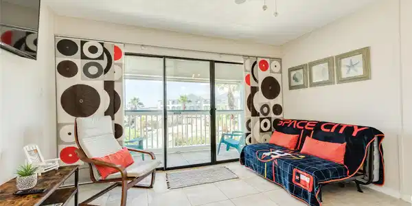 Image 3: Spacious interior with wall of windows leading to