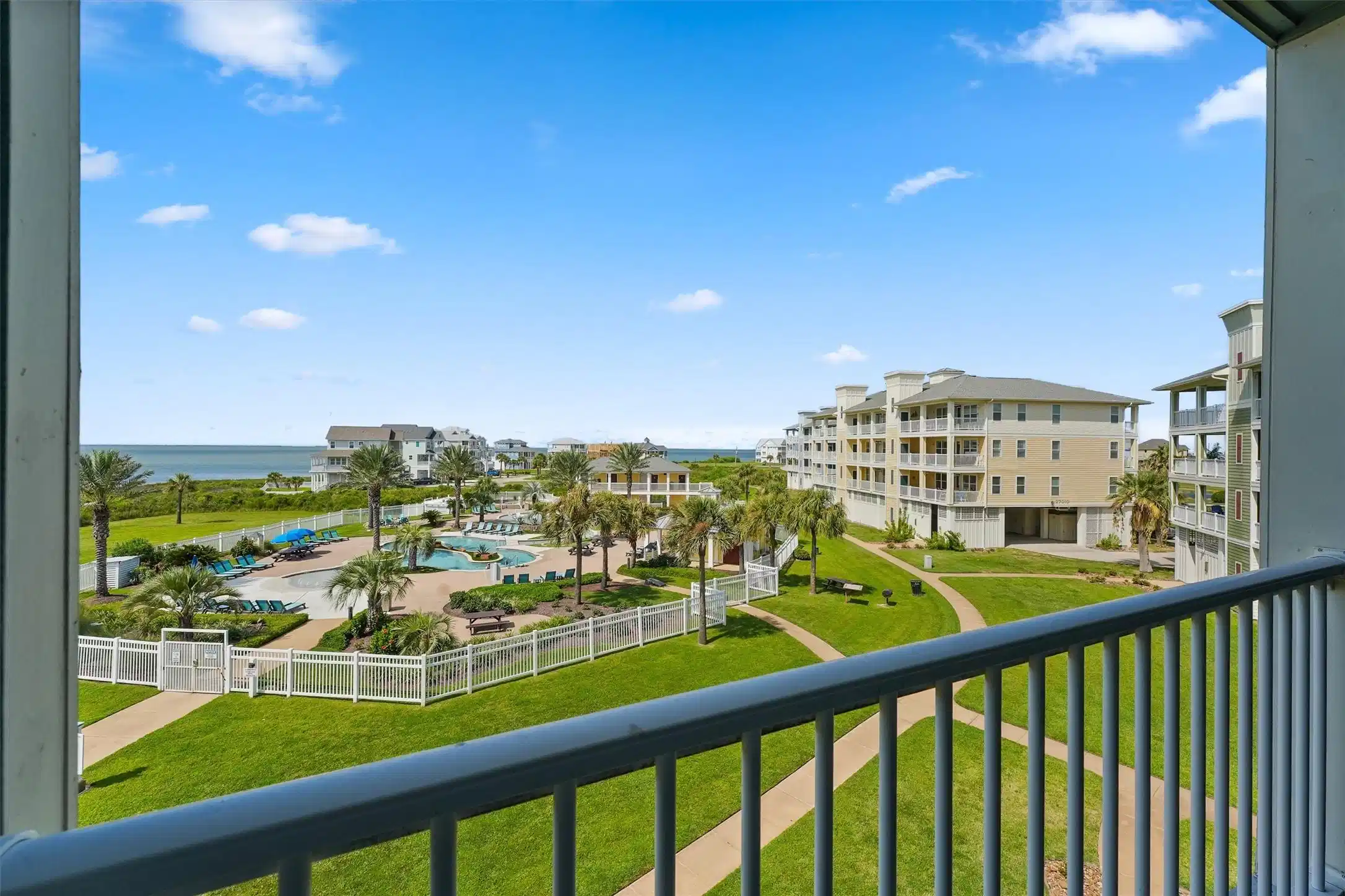 Image 1: Uninterrupted pool and bay views provide a constan