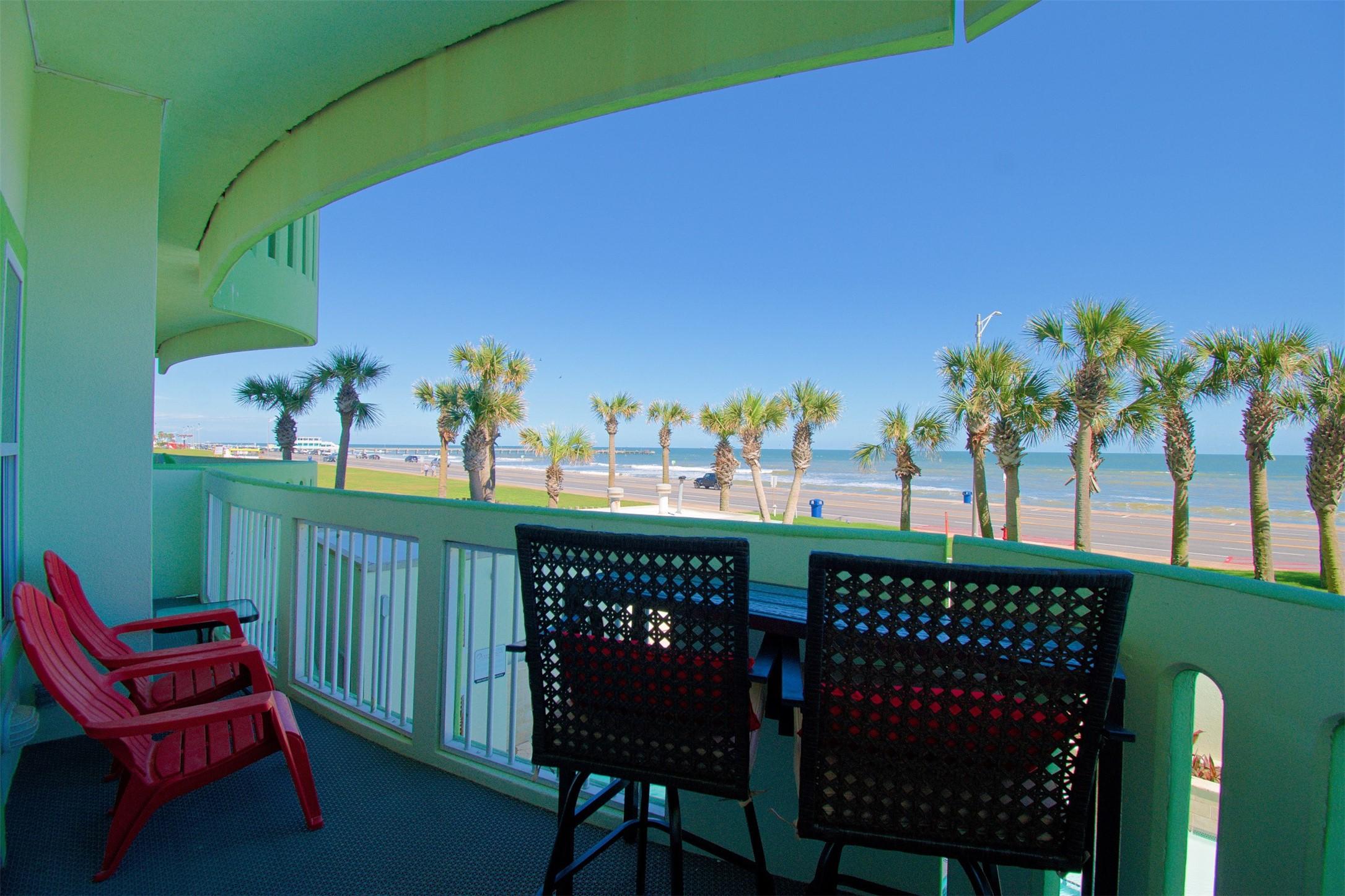 Image 2: Beachfront balcony with a cozy seating area, offer