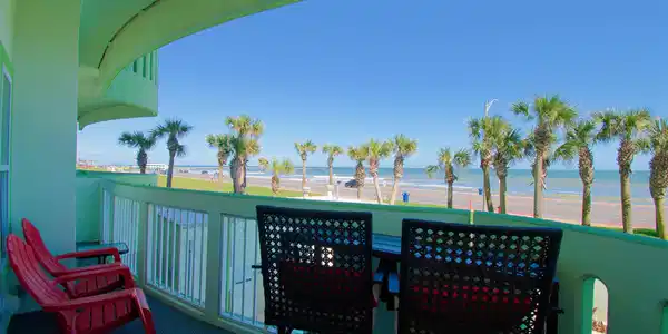 Image 2: Beachfront balcony with a cozy seating area, offer