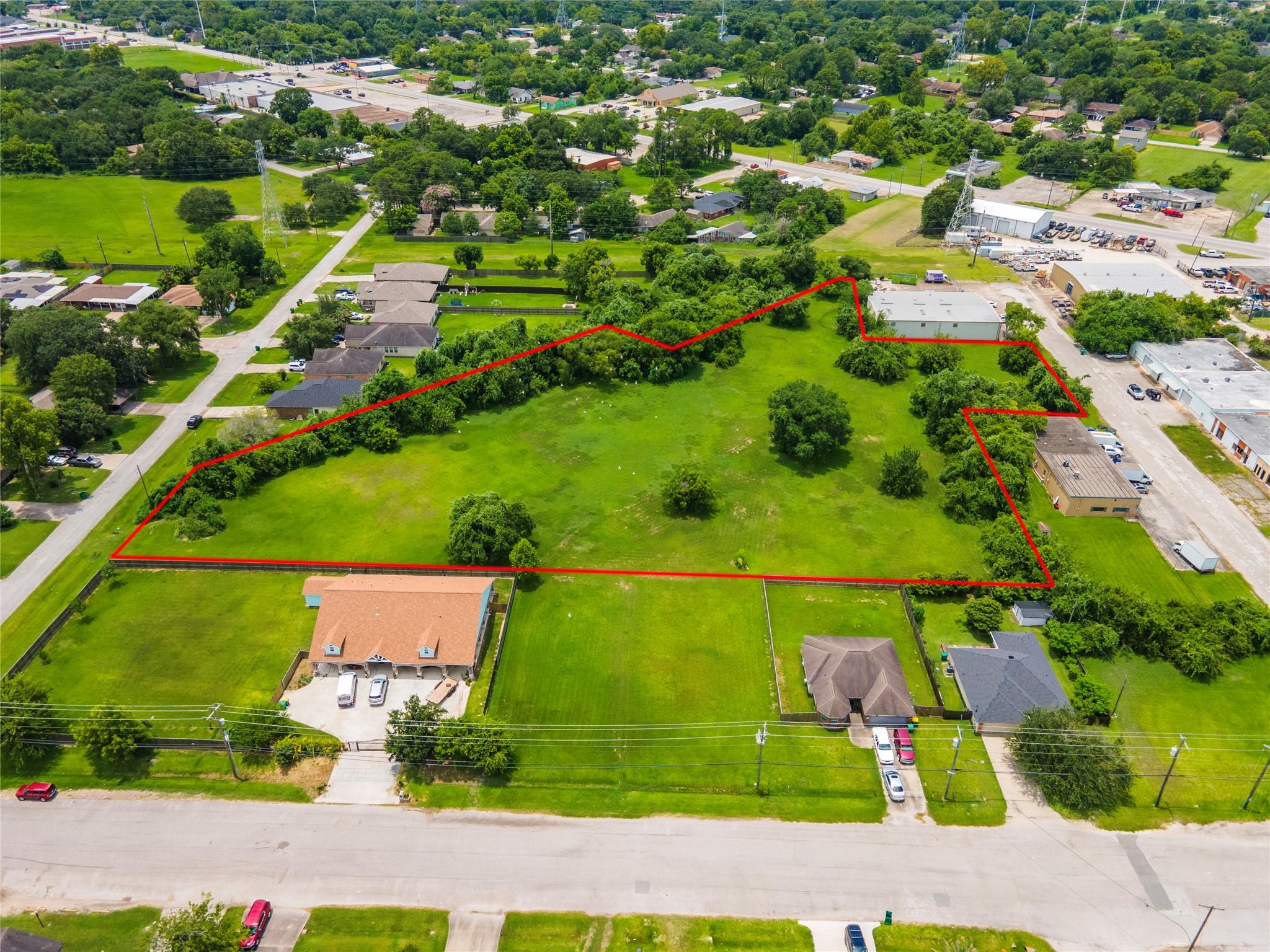 Image 3: Wide aerial view emphasizing the property&rsquo;s open i