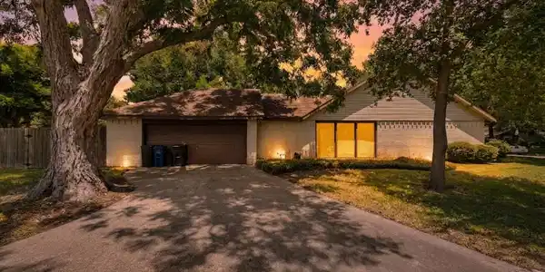 Image 2: Welcome home to wide driveway and two car garage.