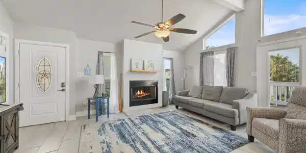 Image 4: The welcoming living room features tile flooring,