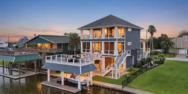 Image 2: From the water, this canal-front home showcases th
