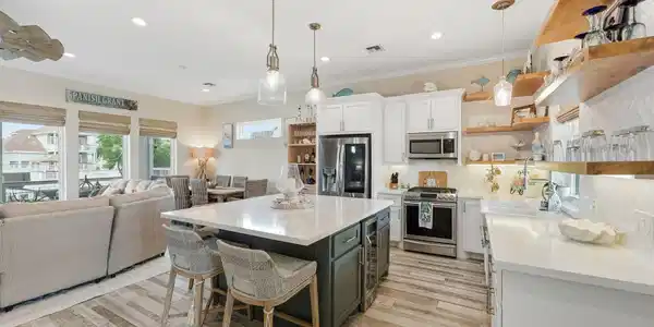 Image 4: The bright, open-concept kitchen and living area c