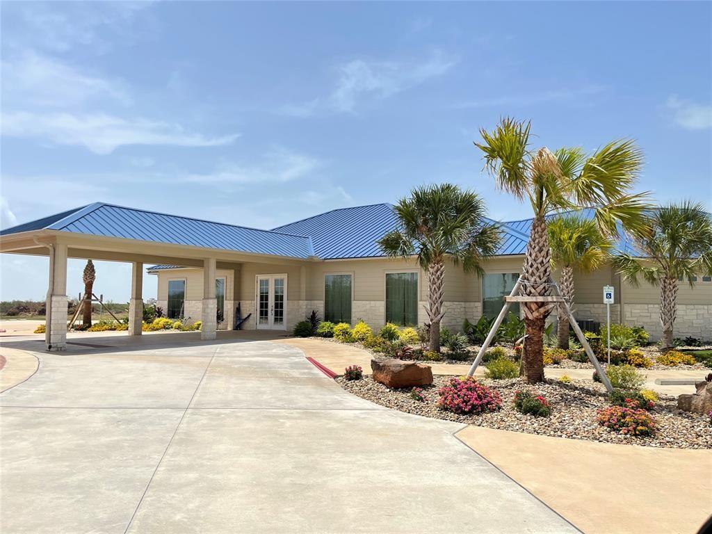 Image 4: Modern single-story home with a blue metal roof, c