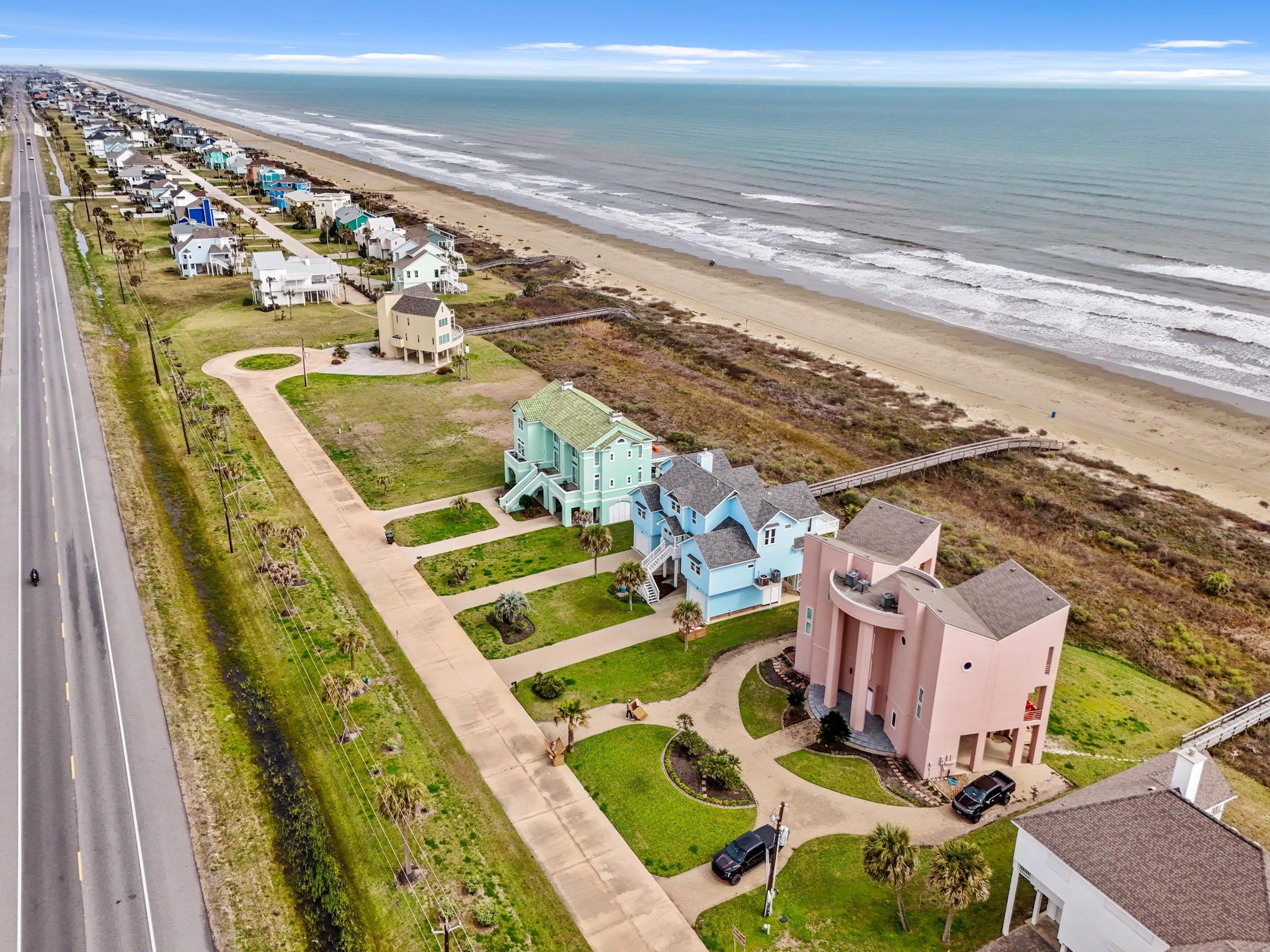 Image 3: Aerial view of the home looking toward the beach.