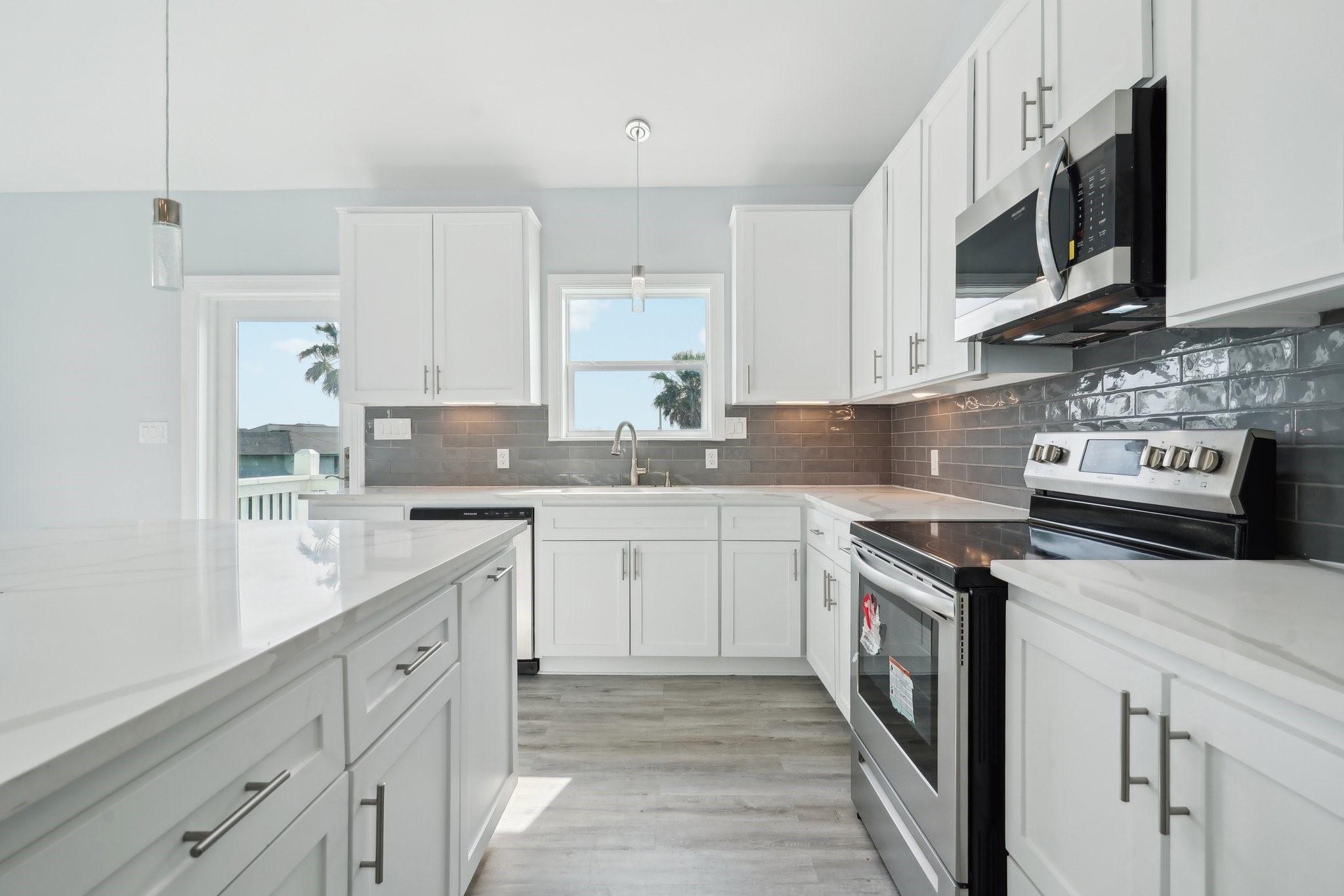 Image 4: The spacious island provides ample counter space,