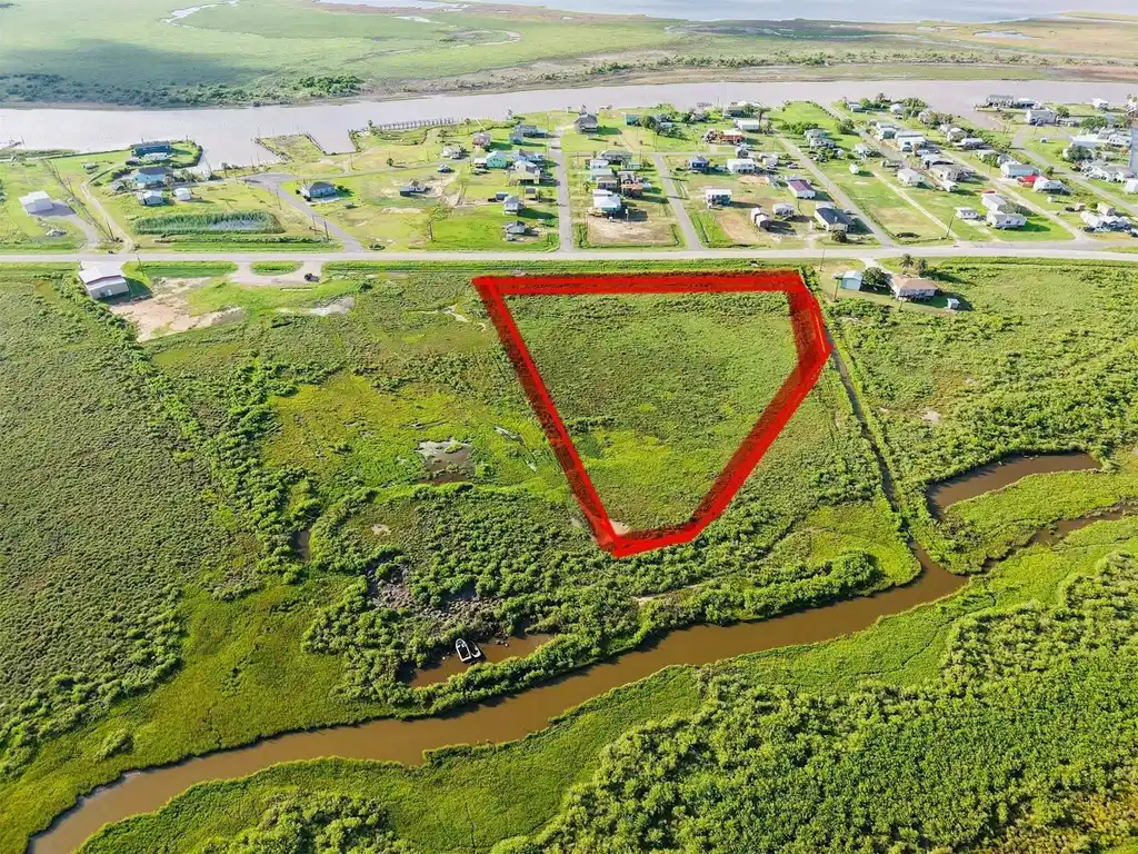 Image 1: This aerial photo showcases a spacious 5 acres plo