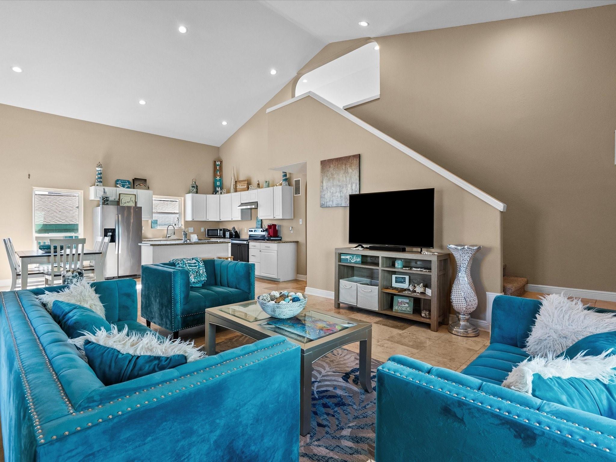 Image 2: This inviting open-plan living area features high