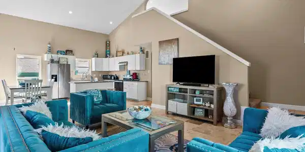 Image 2: This inviting open-plan living area features high
