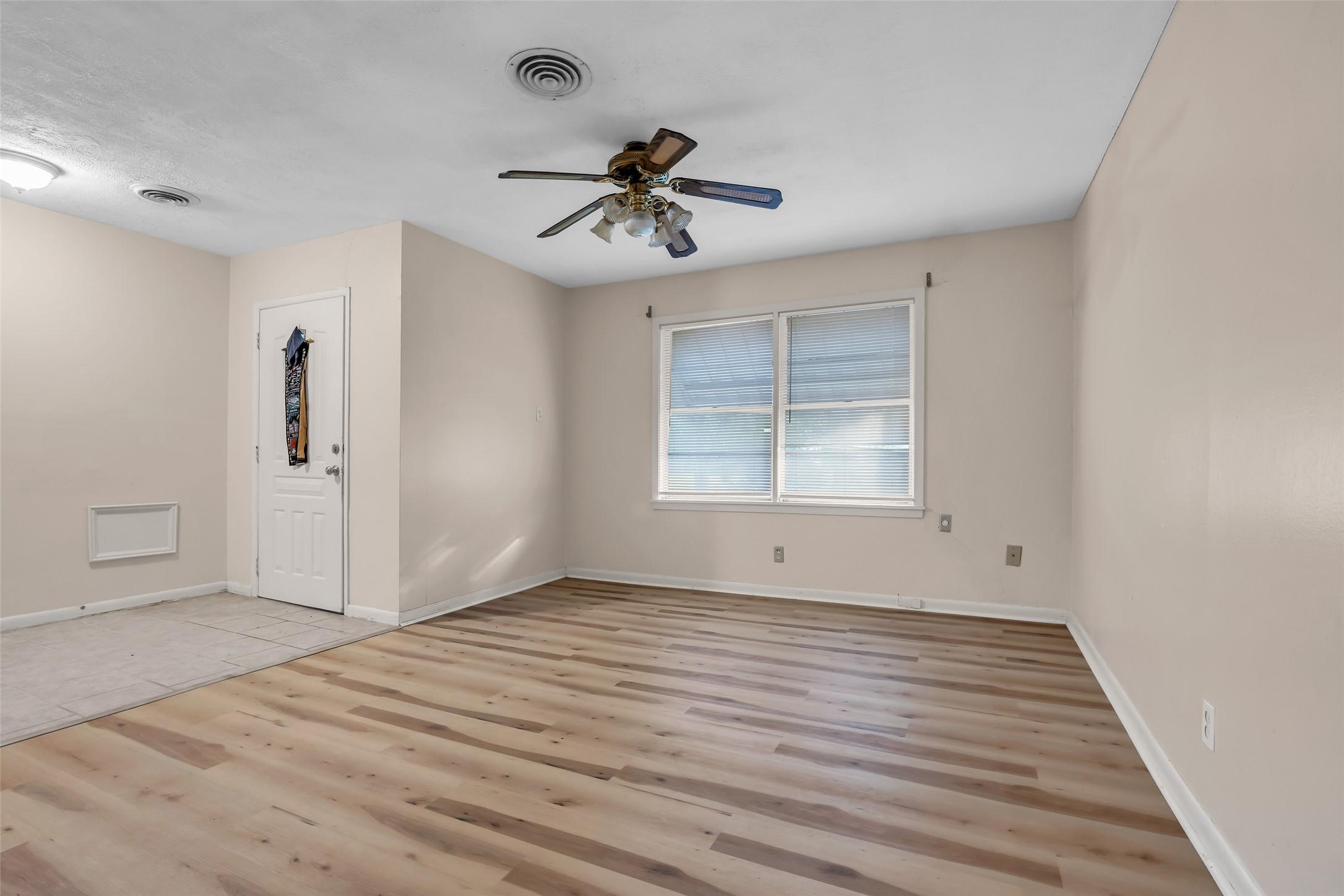 Image 3: Bright, freshly updated interior featuring wood-st