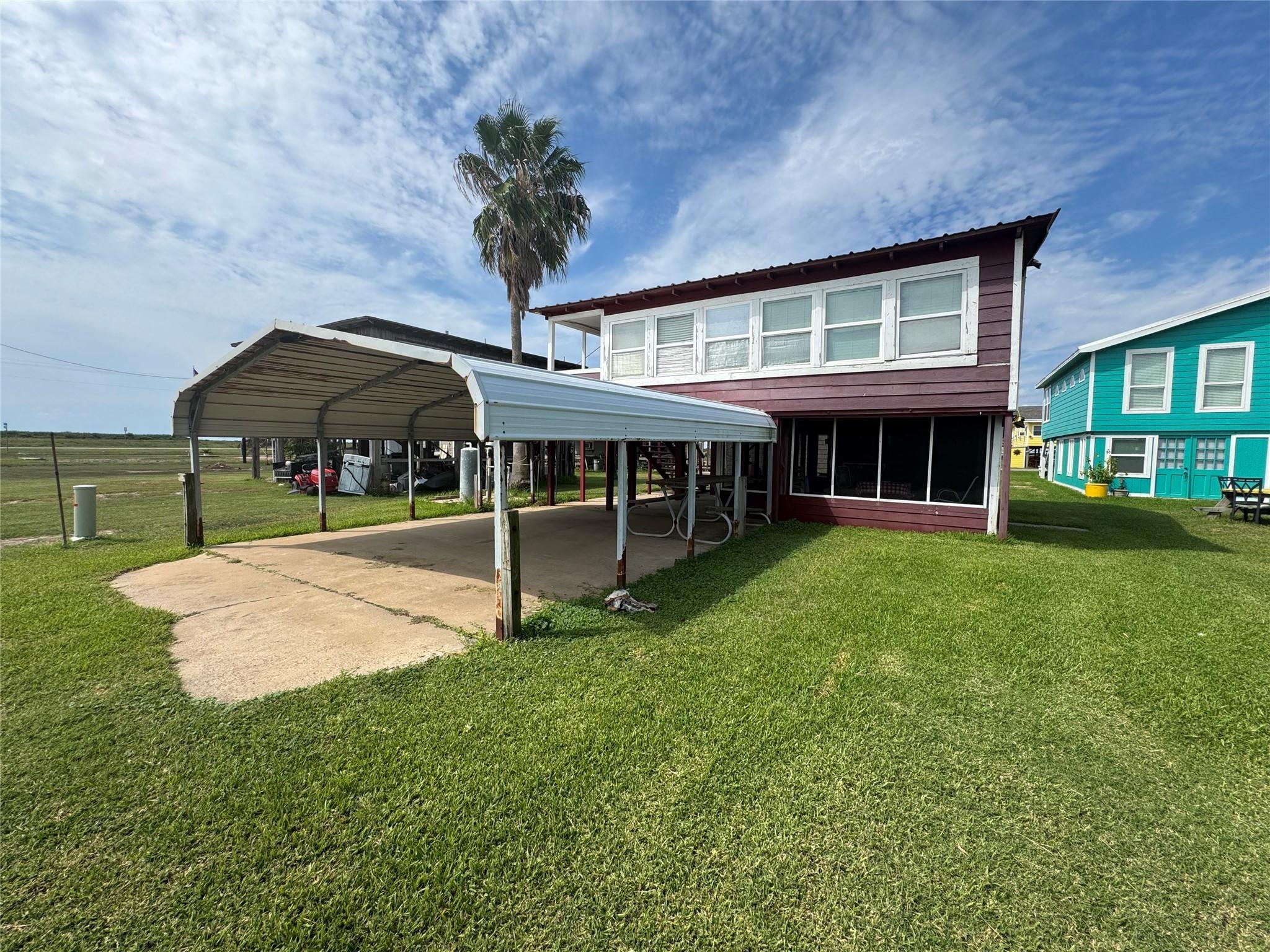 Image 1: An expansive covered patio stretches across the fr