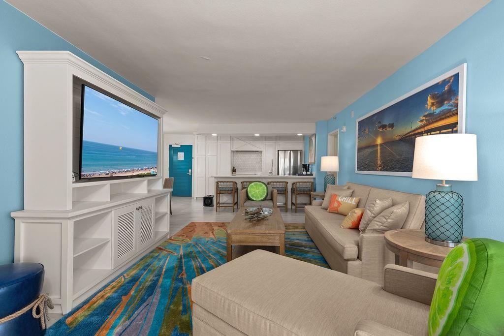 Image 2: Bright, coastal-themed living room with ocean view