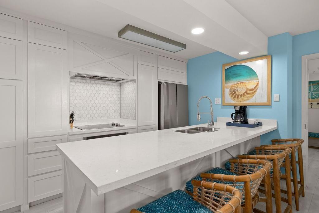 Image 4: This kitchen features a sleek, modern design with