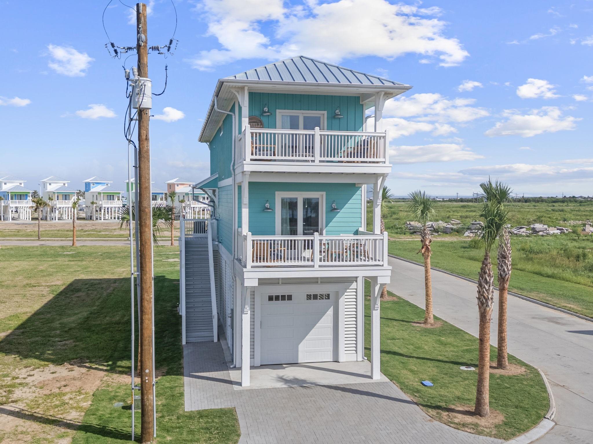 Image 2: Front exterior view featuring elevated beach home
