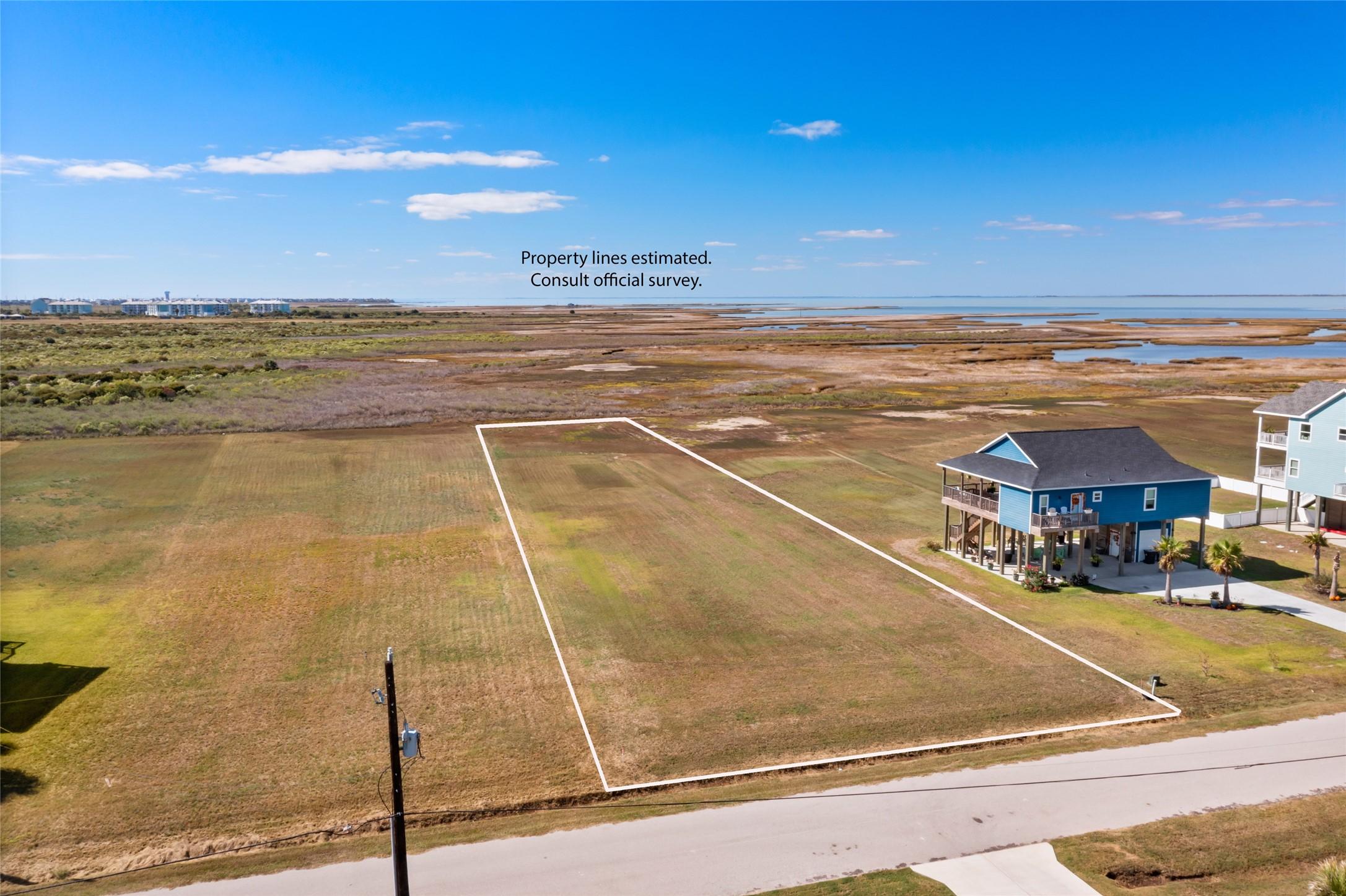 Image 2: This photo shows a spacious, grassy plot of land i