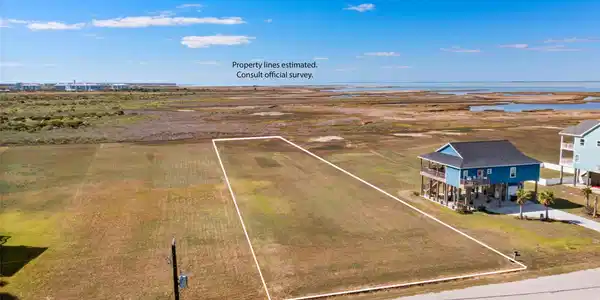 Image 2: This photo shows a spacious, grassy plot of land i