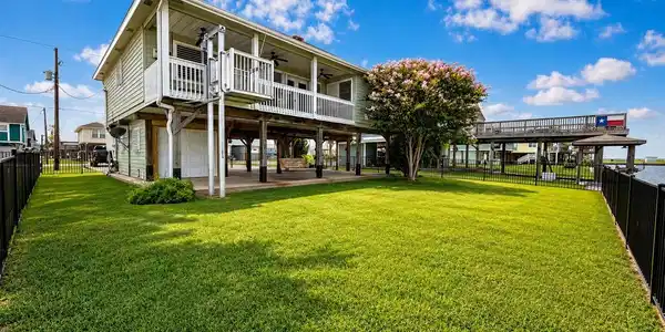 Image 2: This property features a well-kept, two-story home