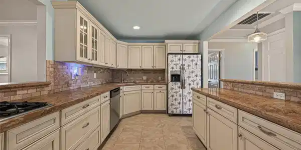 Image 3: Ample counter top space! Clean custom cabinets, so