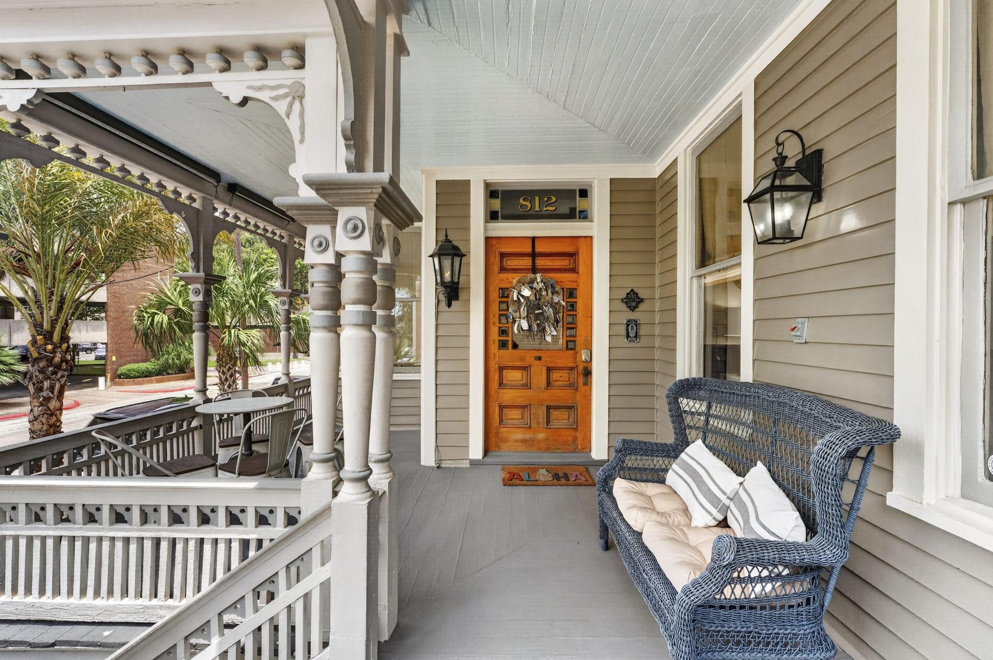 Image 2: Expansive wraparound front porch designed for rela