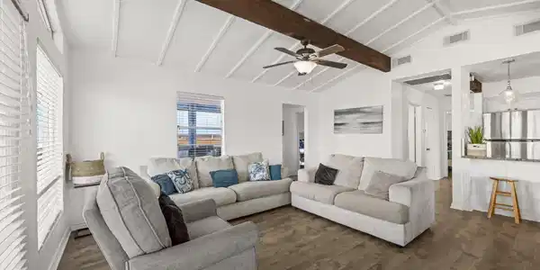 Image 3: Bright, open living room featuring vaulted ceiling
