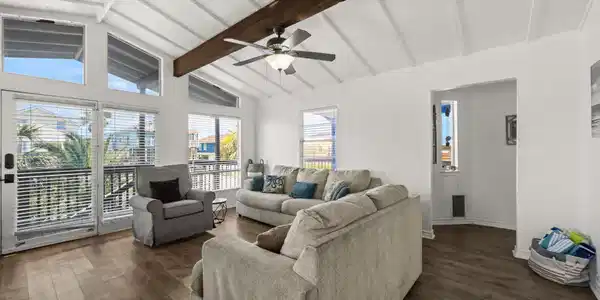 Image 4: Expansive windows and a glass door to the covered