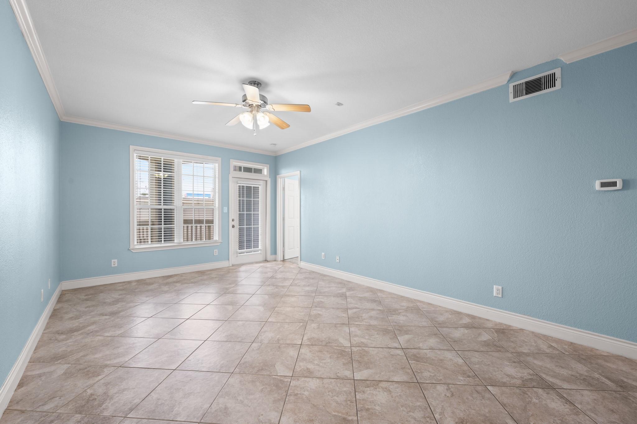 Image 3: Spacious open-concept living area with tile floori