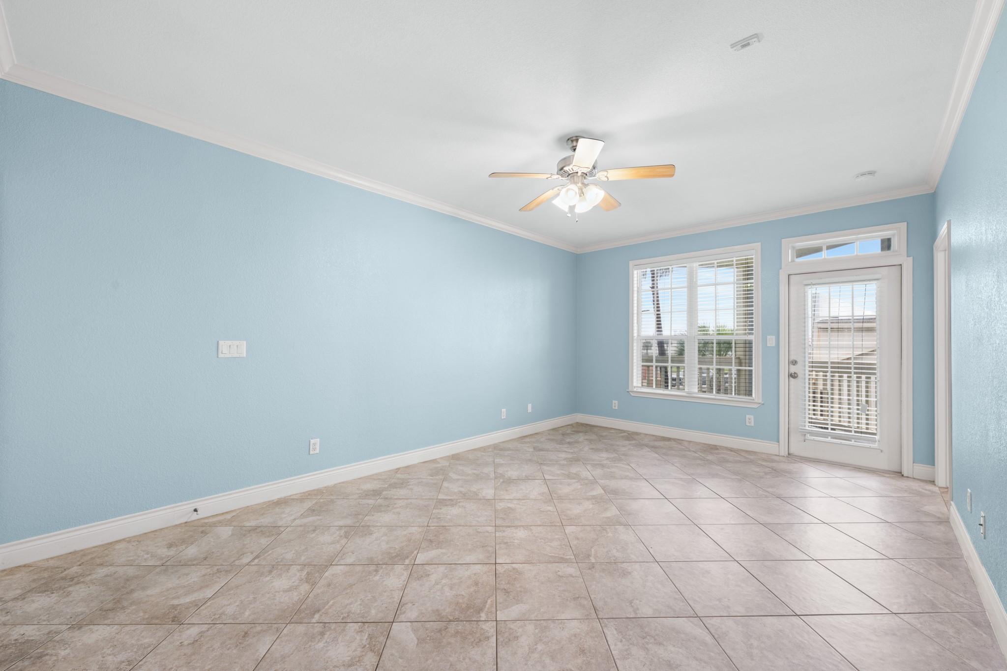 Image 4: Spacious open-concept living area with tile floori