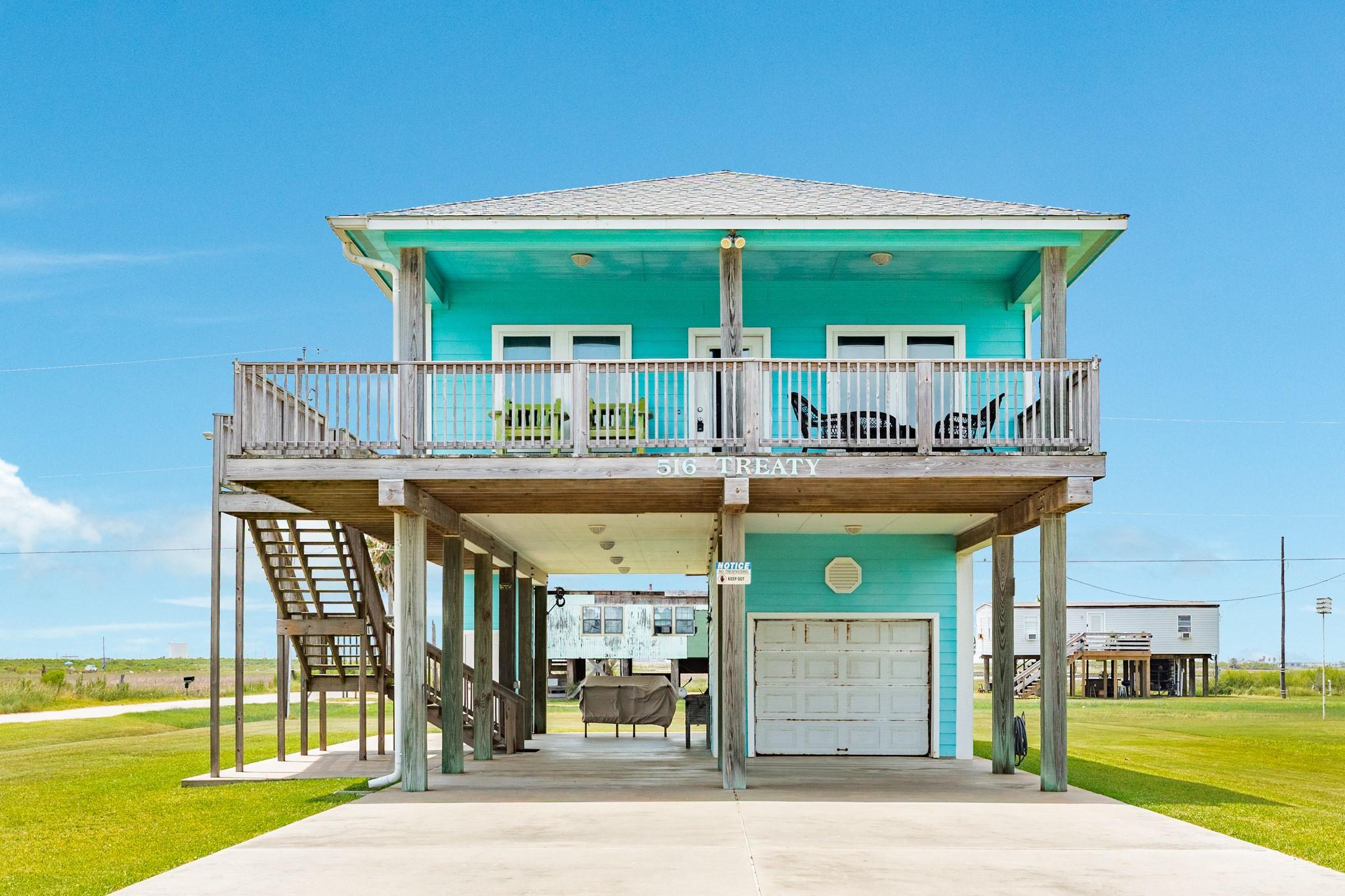 Image 1: Front Exterior &ndash; Elevated coastal home with a spac