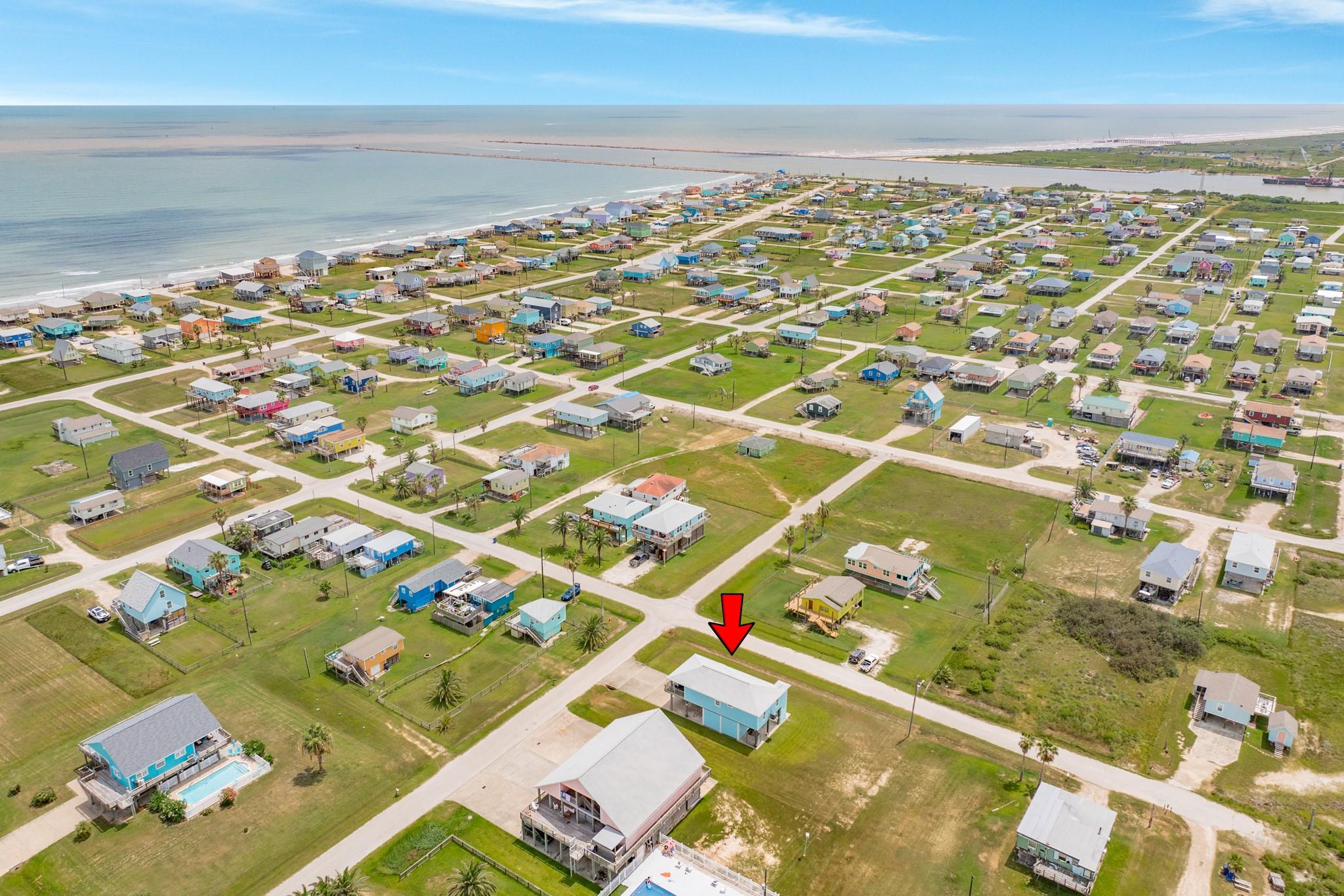 Image 2: Coastal Community View &ndash; Wide aerial capturing the