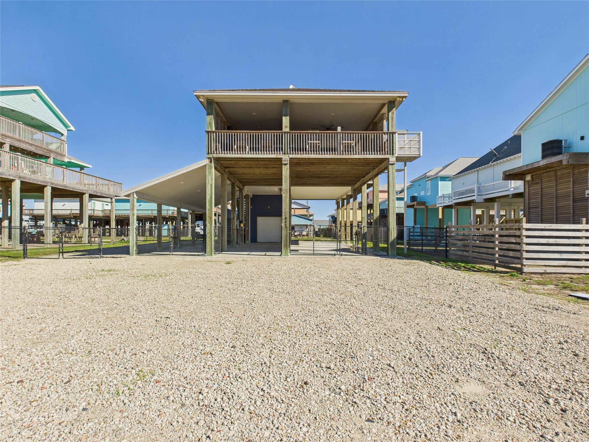 Image 1: Elevated beach house with a spacious gravel drivew